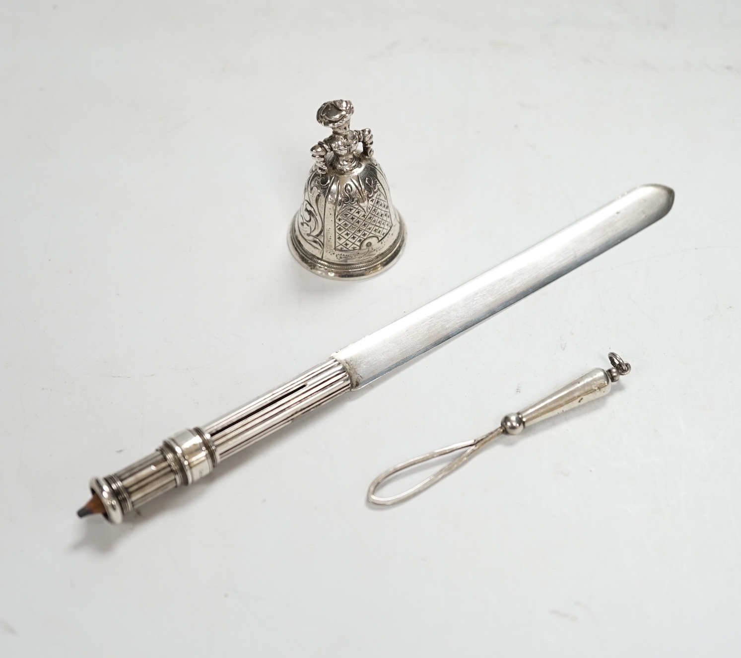 An early 20th century Hanau? miniature figural table bell, 46mm, a late Victorian silver combination paper knife and pencil, Arthur Downing Ltd?, Birmingham, 1897 and a late Victorian silver and Scottish hardstone set ri